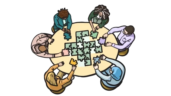 Menschen sitzen an einem runden Tisch und lösen ein Puzzle gemeinsam.